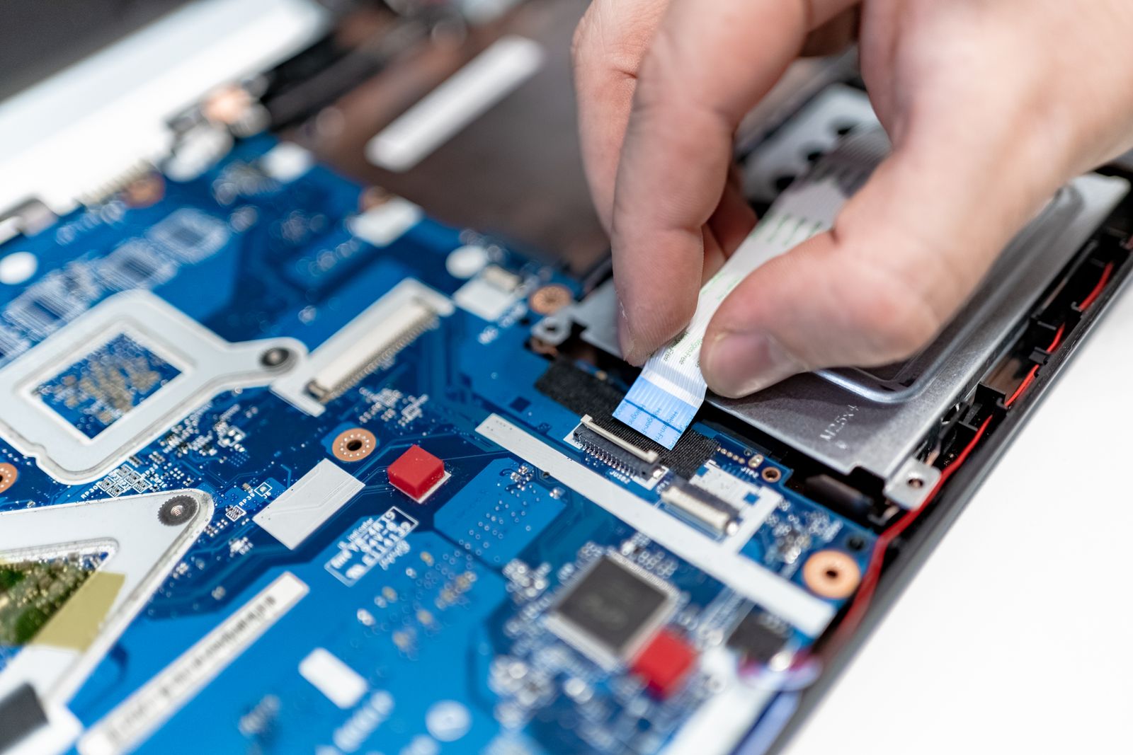 Technician repairing a laptop on a workbench in Deltona FL