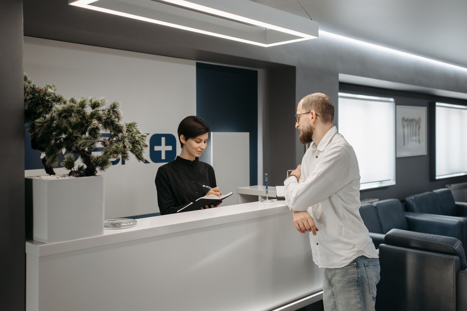 Welcoming small office reception desk with phone and computer